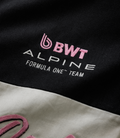 Close-up of black fabric with pink BWT embroidery and white Alpine lettering