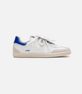 White Duke and Dexter sneaker with blue heel collar seen in a close side view highlighting blue detailing and stitching.