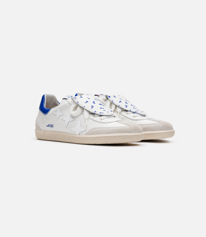 Duke and Dexter Plus Duke sneaker in white with a blue heel tab from the BWT Alpine collaboration, viewed from a low angle.