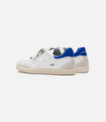 White and blue Duke and Dexter Plus Duke sneaker with a blue heel tab, side view showing leather and suede panels.