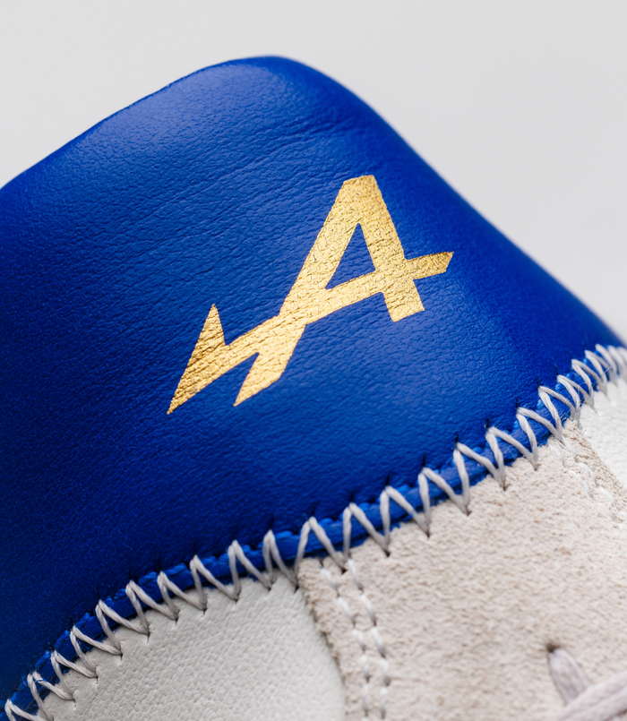 Blue leather sneaker upper with a gold embossed emblem from the BWT Alpine x Duke + Dexter collaboration