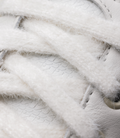 Close-up of plush white fur lining with a glimpse of the sneaker sole