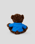Back view of a brown plush bear wearing a blue hoodie