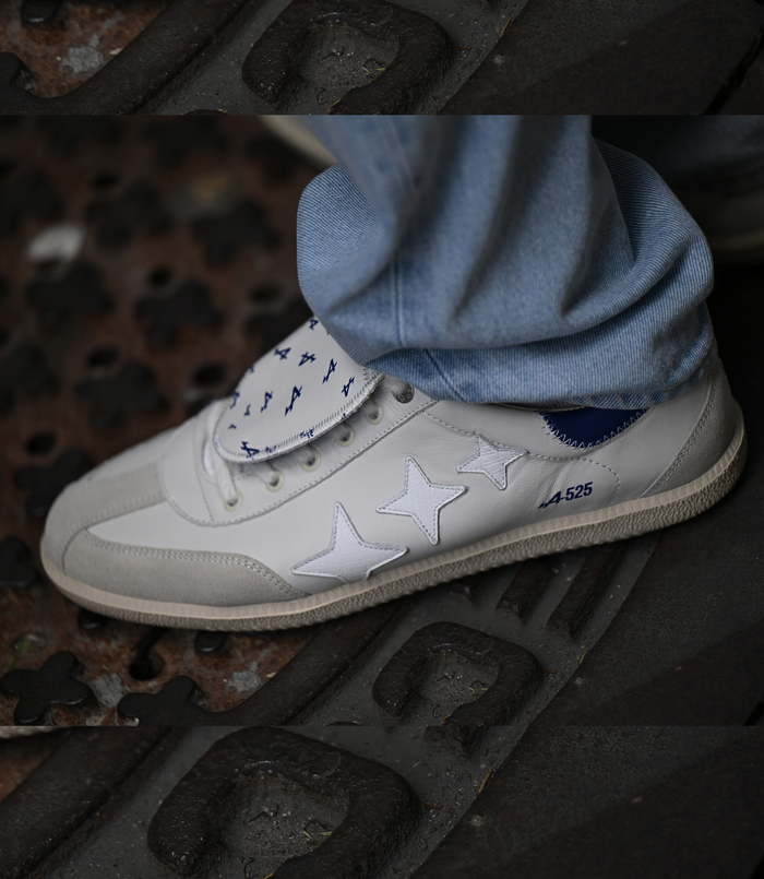White Duke + Dexter sneaker featuring blue star details and A525 text, paired with a blue denim scarf