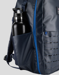 Side pocket with water bottle in navy TYRO 20L backpack.