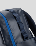Close up of the TYRO 20L backpack strap with jacquard webbing and a blue zipper