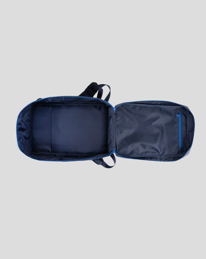 TYRO 20L backpack opened flat showing interior compartments and a blue zip pocket on the right panel
