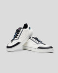 Pair of white and black Endstate sneakers with blue detailing shown together on a gray background