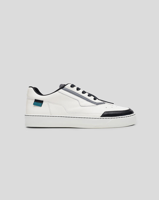 Side profile of a white Alpine Endstate sneaker with a black toe cap and grey midsection