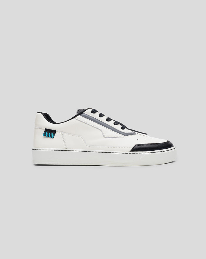 Side profile of a white Alpine Endstate sneaker with a black toe cap and grey midsection