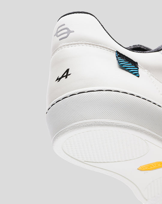 Rear view of a white Alpine Endstate sneaker with black accents and a blue striped heel patch