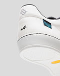 Rear view of a white Alpine Endstate sneaker with black accents and a blue striped heel patch