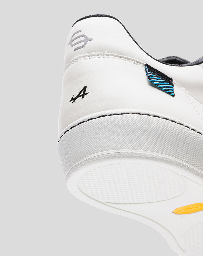 Rear view of a white Alpine Endstate sneaker with black accents and a blue striped heel patch