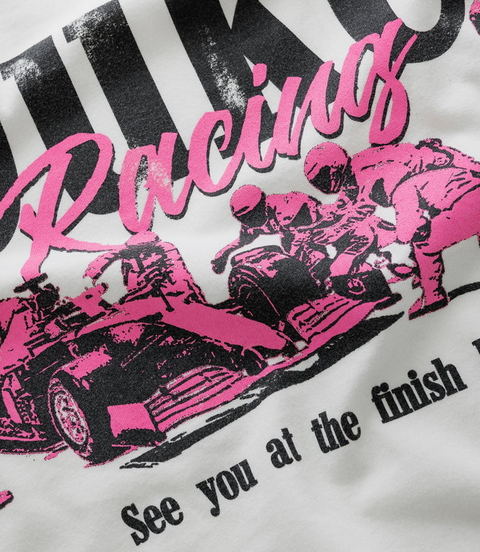 Front view of white vintage T shirt with bold Duke Racing script and crest graphic