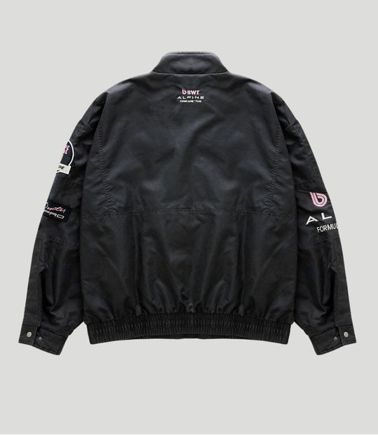 Back view of a black BWT Alpine trackside jacket with pink BWT logo on the upper back.