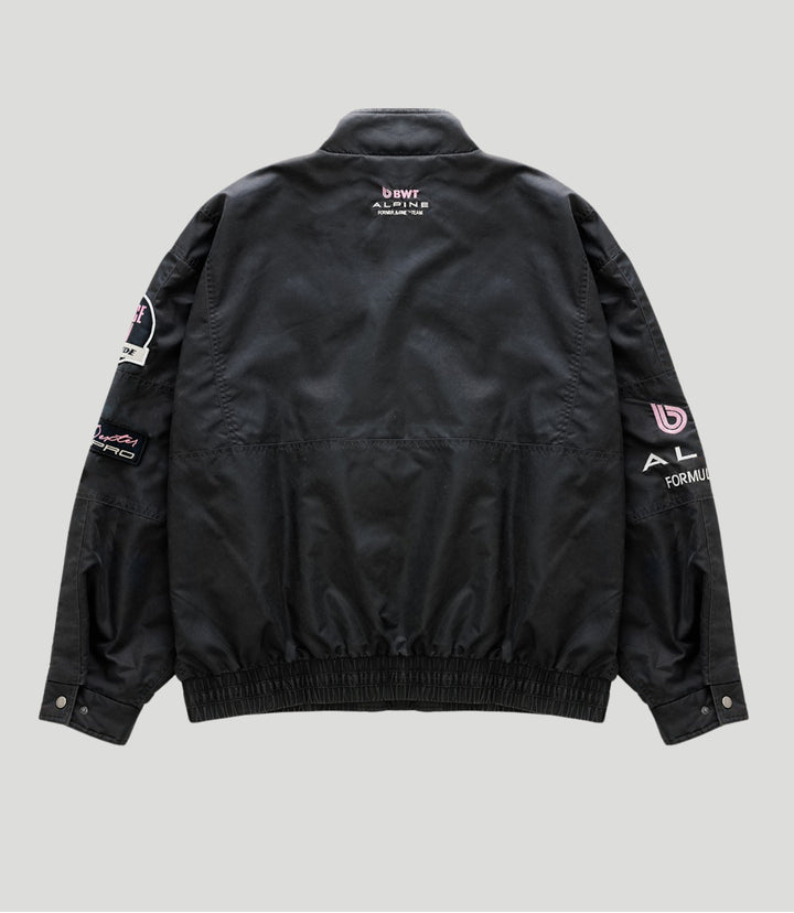 Back view of a black BWT Alpine trackside jacket with pink BWT logo on the upper back.