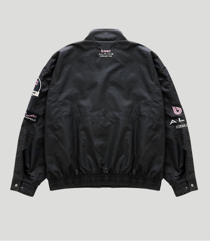 Back view of a black BWT Alpine trackside jacket with pink BWT logo on the upper back.