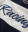 Embroidered winged emblem and Duke & Dexter script on navy racing jacket patch