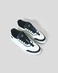 Overhead view of white and black BWT Alpine Endstate sneaker with blue accents and tongue tag