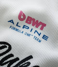 White waffle fabric close up with pink BWT ALPINE branding and blue text details