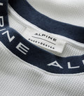 Navy fabric strap with a white label reading ALPINE and DUKE+DEXTER on white textured fabric