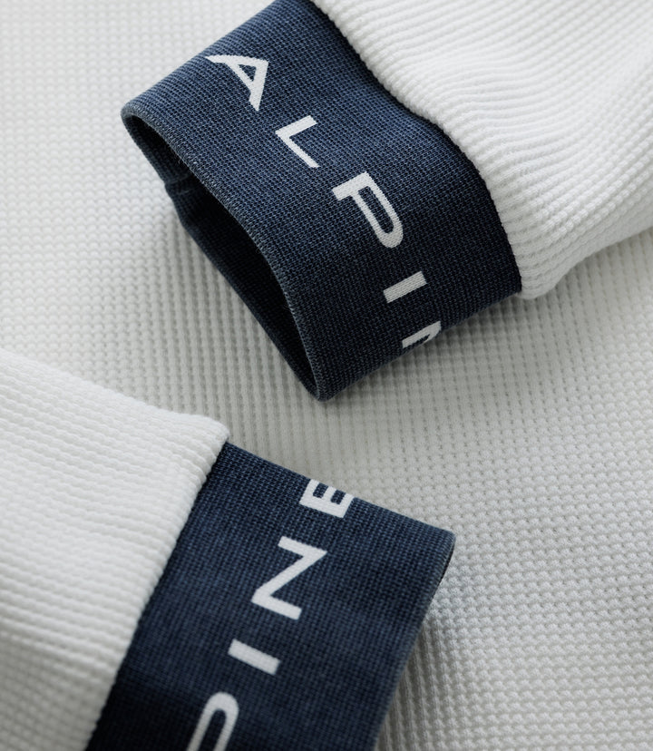 Close-up of a navy cuff on a white BWT Alpine Duke & Dexter waffle sock with white branding on the cuff