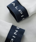 Close-up of a navy cuff on a white BWT Alpine Duke & Dexter waffle sock with white branding on the cuff