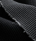 Close up of black washed waffle jersey fabric texture