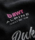 White Alpine label stitched to a black washed waffle jersey