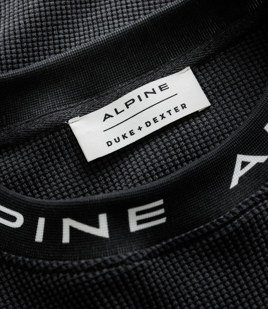 White Duke & Dexter label stitched to black waffle jersey