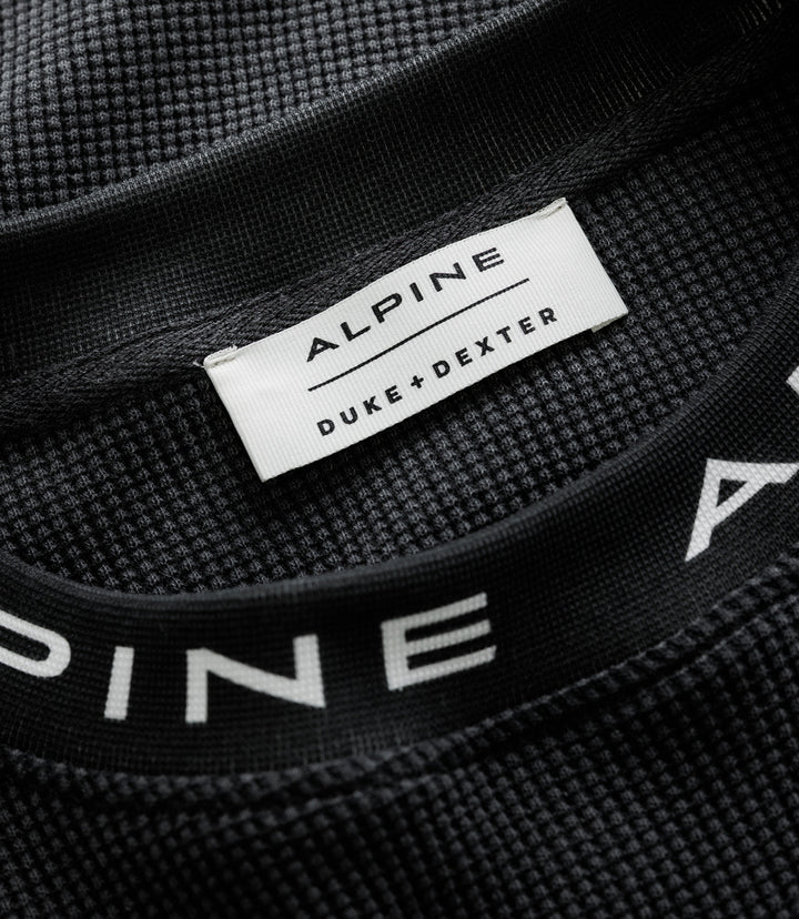 White Duke & Dexter label stitched to black waffle jersey