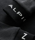 Close up of black jersey edge showing white Alpine letters printed on the fabric fold