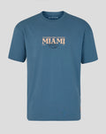 Front view of blue Miami Race Graphic T Shirt with large pale MIAMI text on chest