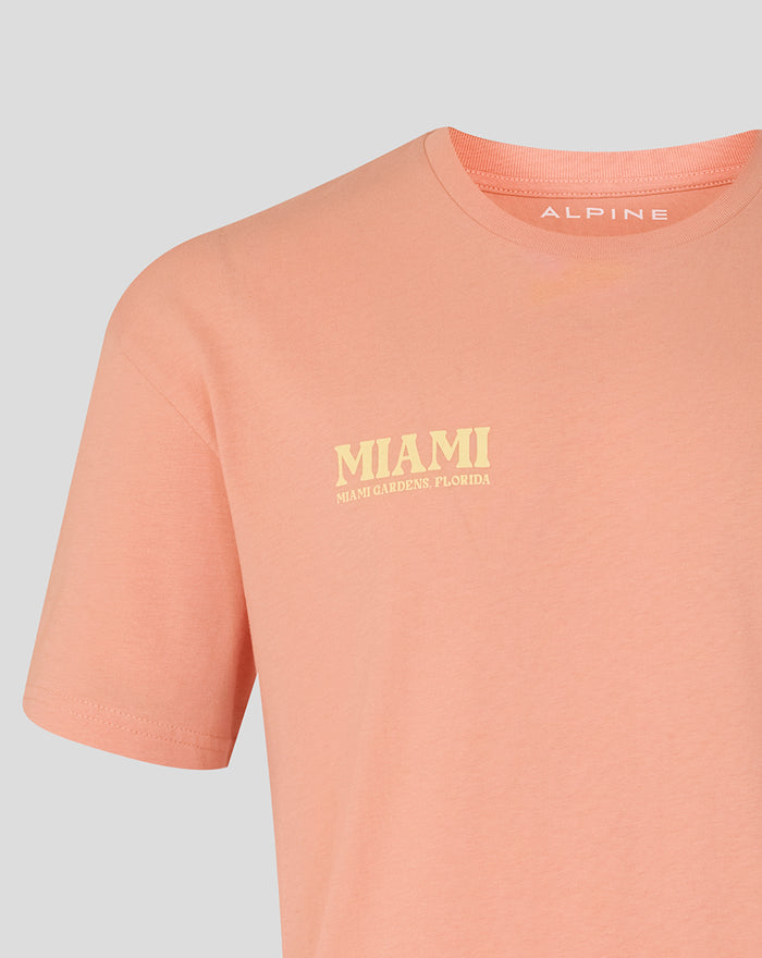 Close-up of coral pink Miami T-shirt with left chest Miami graphic and Alpine branding at the neckline.