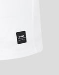 Hem area of white T shirt showing a black BWT Alpine patch with Formula One Team branding