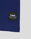 Close-up of navy T shirt hem featuring a black BWT Alpine patch with Formula One Team branding