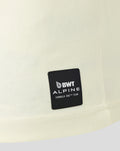 Close up of the black BWT Alpine patch on the cream fabric near the hem