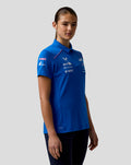 Back view of a woman in a blue BWT Alpine Formula One team polo with large branding on the back