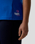 Blue polo shirt on a model in a three-quarter view with team logos and the Change the World graphic on the hem.