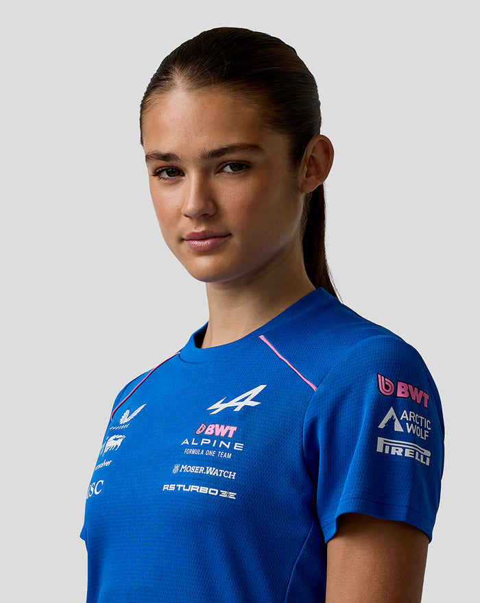 Close-up of a woman in a blue BWT Alpine Driver Set Up T Shirt, highlighting chest logos