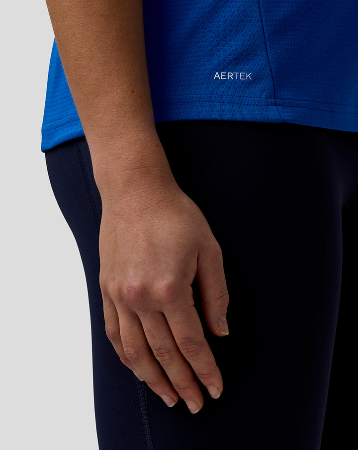 Blue BWT Alpine official women's F1 team T shirt close up highlighting AerTek wordmark at the hem