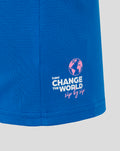 Close up of blue polo sleeve with pink BWT logo and Oakberry branding including a globe graphic and Change the World sip by sip slogan.