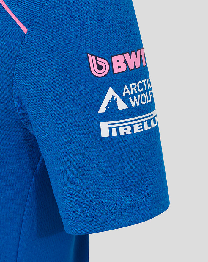 Close-up of blue polo shirt sleeve showing pink BWT logo and Oakberry branding.