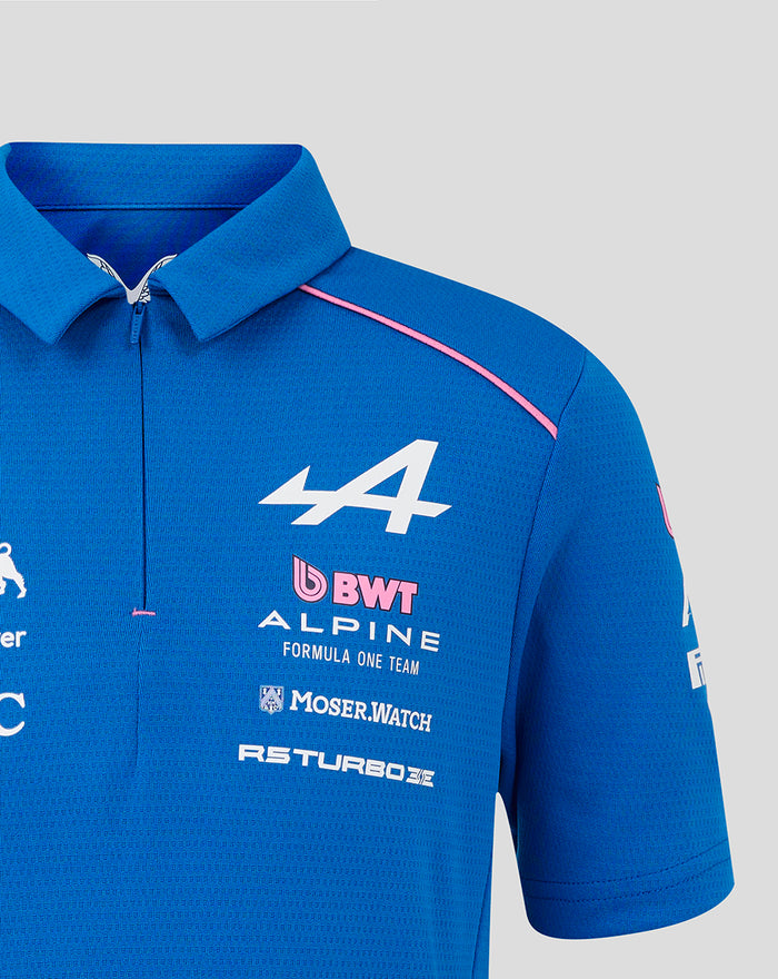 Blue polo shirt front close up with large white A4 logo BWT Alpine branding and pink shoulder piping plus a concealed zip