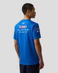 Back view of a blue BWT Alpine Formula One Team Set Up T Shirt on a model, large Alpine and sponsor logos on the back.