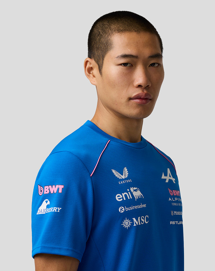 Male model wearing bright blue BWT Alpine Formula One Team Set Up T Shirt with pink piping and sponsor logos on chest
