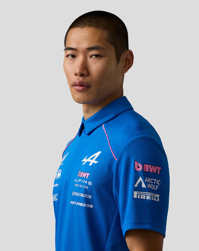 Side view of a model in a blue BWT Alpine Formula One Team polo shirt with sponsor logos.