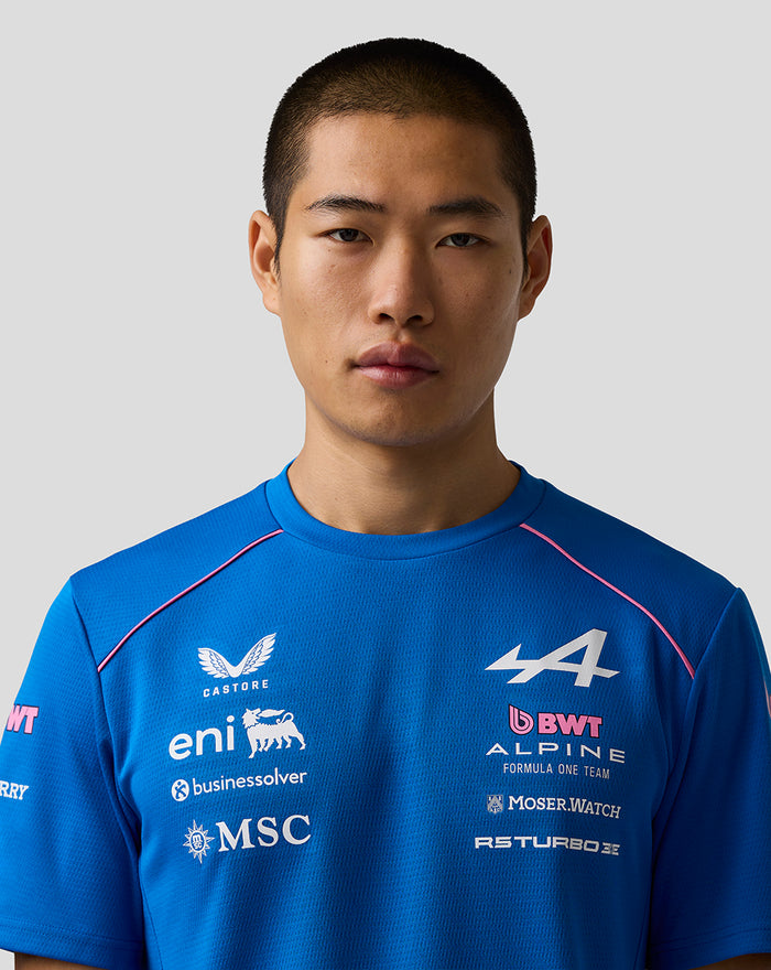 Male model in blue BWT Alpine Formula One Team T shirt displaying logos on the front.