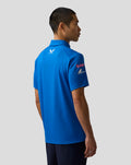 Back view of a man wearing a bright blue BWT Alpine polo with a small Castore logo on the upper back