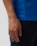 Close up of blue BWT Alpine polo showing AerTek text near the hem and concealed zip puller.